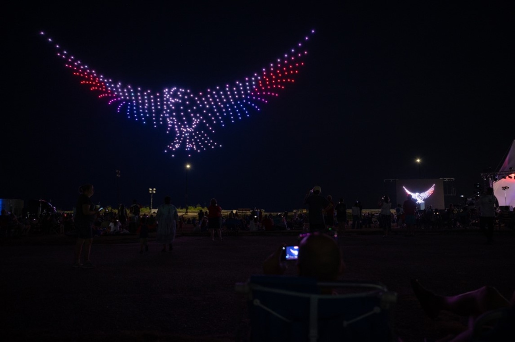 Attendees watch drones form a bird shaped display. (U.S. Air Force photo by Airman 1st Class Donnell Ramsey)
