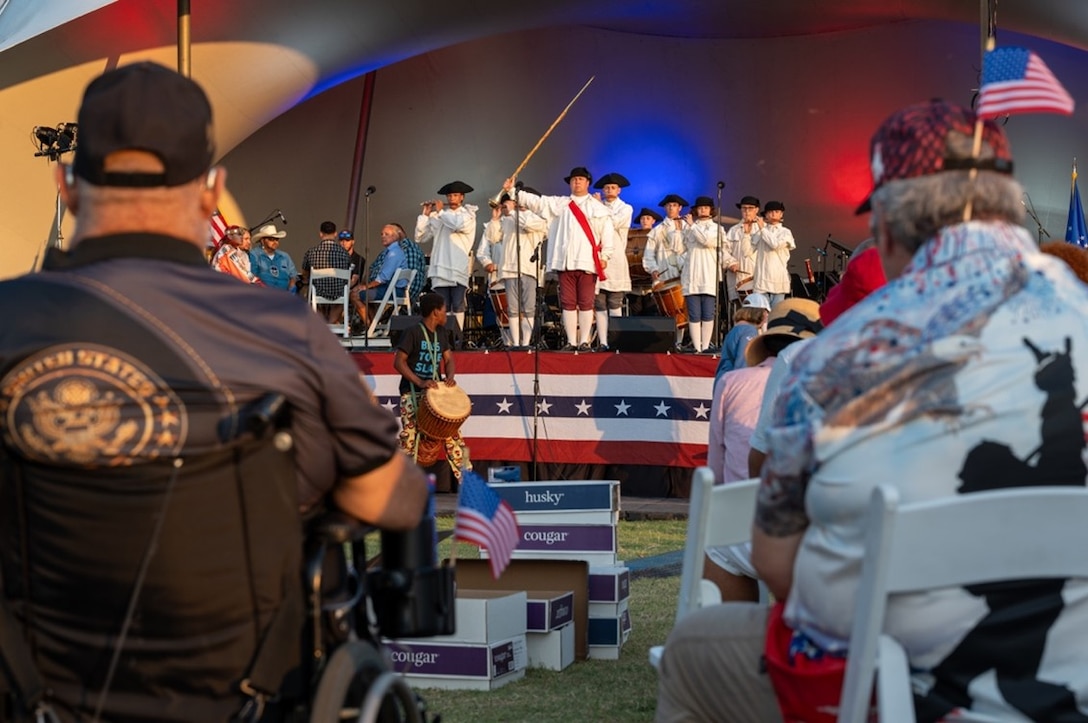 Attendees watch a band perform on stage. (U.S. Air Force photo by Airman 1st Class Donnell Ramsey)