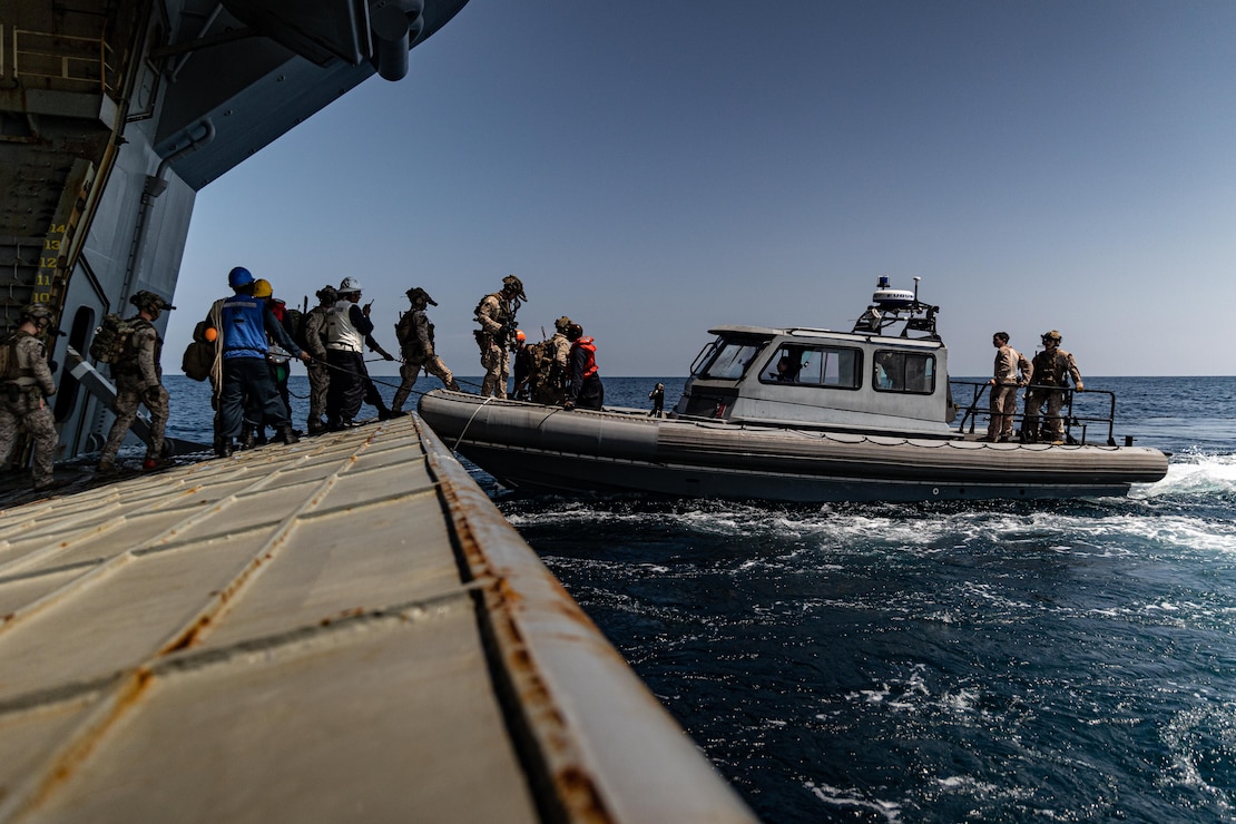 U.S. Marines with Maritime Special Purpose Force, 22nd Marine Expeditionary Unit (Special Operations Capable), load onto an enhanced rigid-hull inflatable boat for maritime interdiction operations from the U.S. Navy Wasp-class amphibious assault ship USS Iwo Jima (LHD 7), in support of Composite Training Unit Exercise while underway in the Atlantic Ocean, June 26, 2025.