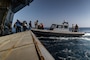 U.S. Marines with Maritime Special Purpose Force, 22nd Marine Expeditionary Unit (Special Operations Capable), load onto an enhanced rigid-hull inflatable boat for maritime interdiction operations from the U.S. Navy Wasp-class amphibious assault ship USS Iwo Jima (LHD 7), in support of Composite Training Unit Exercise while underway in the Atlantic Ocean, June 26, 2025.