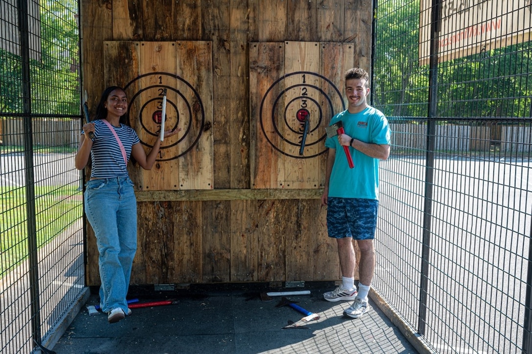 Airmen pose in front of throwing board. (U.S. Air Force photo by Airman 1st Class Donnell Ramsey)