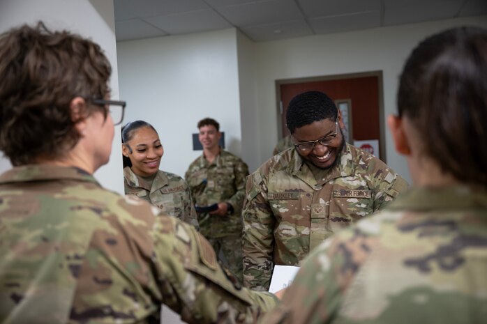 A group of Airmen out process.