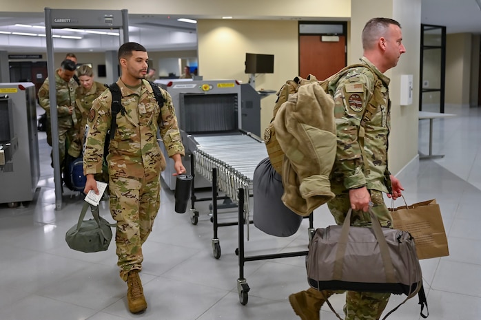 A group of Airmen out process.