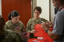 A group of Airmen out process.
