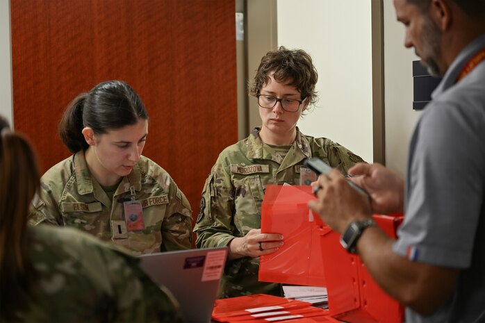 A group of Airmen out process.