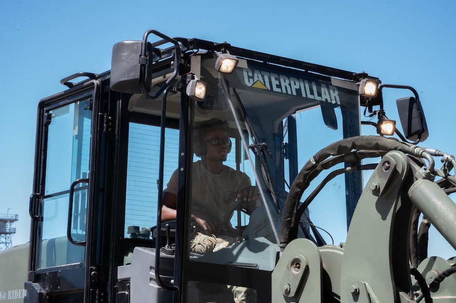 Airman 1st Class James Davies, 5th Logistics Readiness Squadron (5LRS) transportation management organization inbound cargo technician, drives a forklift to a C-5M Super Galaxy at Minot Air Force Base, North Dakota, July 1, 2025. The 5LRS air transportation function helps supply and load gear needed for missions onto aircraft. (U.S. Air Force photo by Airman 1st Class Wesley Davies)