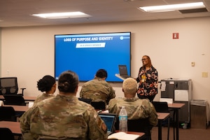 A woman speaking to a class.