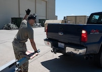 Senior Airman Jonathan Gonzalez-Rodriguez, 5th Logistics Readiness Squadron (5LRS)  air transportation specialist, guides a truck into place to attach a trailer at Minot Air Force Base, North Dakota, July 1, 2025. The 5LRS air transportation function at Minot AFB plays a critical role in ensuring mission success by loading and moving essential cargo to support global operations. (U.S. Air Force photo by Airman 1st Class Wesley Davies)