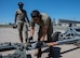 Senior Airman Jonathan Gonzalez-Rodriguez, 5th Logistics Readiness Squadron (5LRS)  air transportation specialist, attaches a trailer to a forklift to bring cargo to a C-5M Super Galaxy at Minot Air Force Base, North Dakota, July 1, 2025. The 5LRS air transportation function is vital to the mission at Minot AFB because it enables the timely delivery of equipment and supplies to missions in and outside of the base. (U.S. Air Force photo by Airman 1st Class Wesley Davies)
