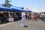 Cmdr. Ryan Doyle, commanding officer of the Independence-variant littoral combat ship USS Omaha (LCS 12), speaks to families as the ship is moored pierside at its homeport of Naval Base San Diego, July 11, 2025. The Omaha returns to Naval Base San Diego following a 10-month rotational deployment to the U.S. 7th Fleet area of operations in support of a free and open Indo-Pacific. Littoral combat ships are fast, optimally manned, mission-tailored surface combatants that operate in near-shore and open-ocean environments, winning against 21st-century coastal threats. (U.S. Navy photo by Mass Communication Specialist 2nd Class Kassandra Alanis)