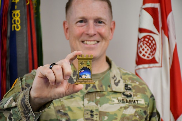 U.S. Army Maj. Gen. David C. Hill, Commandant of the U.S. Army War College and former U.S. Army Corps of Engineers Transatlantic Division commander, shows off his newly received division coin during a special commemorative event on June 11 at the Transatlantic Division headquarters in Winchester, Va.