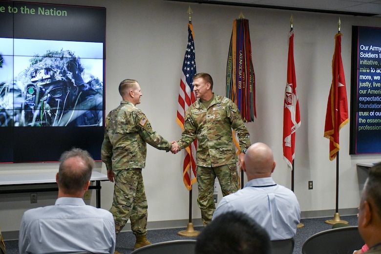U.S. Army Col. Craig S. Baumgartner, U.S. Army Corps of Engineers Transatlantic Division commander, shakes hands with U.S. Army Maj. Gen. David C. Hill, Commandant of the U.S. Army War College and former U.S. Army Corps of Engineers Transatlantic Division commander, at a special commemorative event on June 11 at the division headquarters in Winchester, Va.
