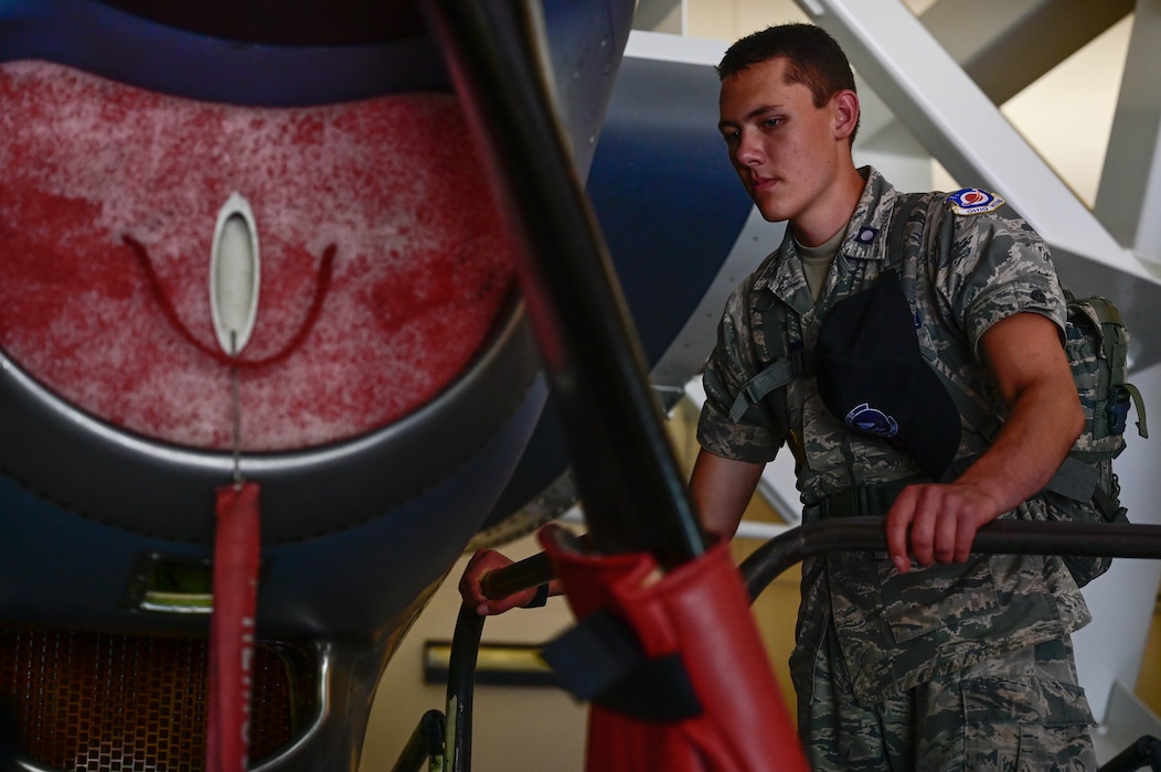 A boy inspects a piece of an aircraft.