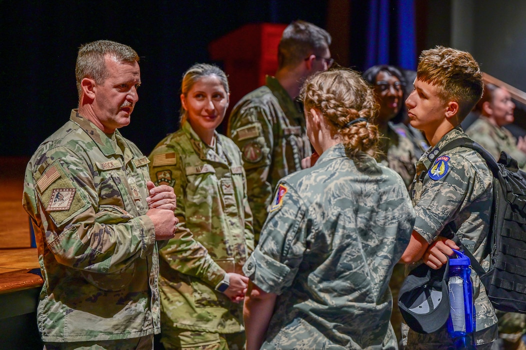 Group of people in uniform talking.
