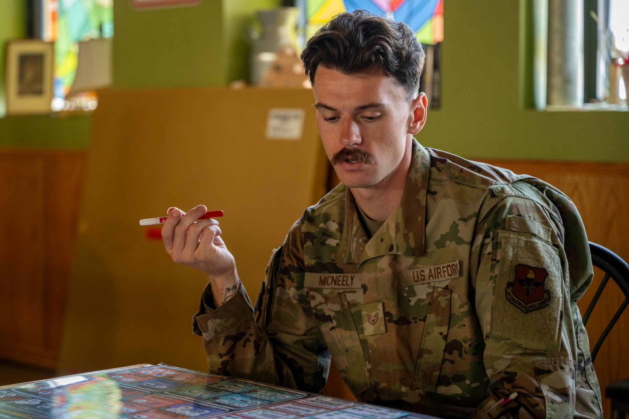U.S. Air Force Staff Sgt. Brenden McNeely, 9th Aircraft Maintenance Unit MQ-9 Reaper aircraft craftsman, plays a game of Kingfish Agile Combat Employment during the Warfighter’s Edge Logistics Symposium at Holloman Air Force Base, New Mexico, July 10, 2025.
