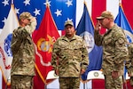 Capt. Robert J. Berry (Left) and Capt. James J. Camp (Right) salute each other during a change of command ceremony for the Coast Guard Maritime Security Response Team West in San Diego, July 9, 2025. Vice Adm. Andrew Tiongson (Center), commander, U.S. Coast Guard Pacific Area, presided over the time-honored military tradition, which represents a formal transfer of authority and responsibility for a unit from one commanding officer to another. (U.S. Coast Guard photo by Petty Officer 3rd Class Ian Nuhfer)