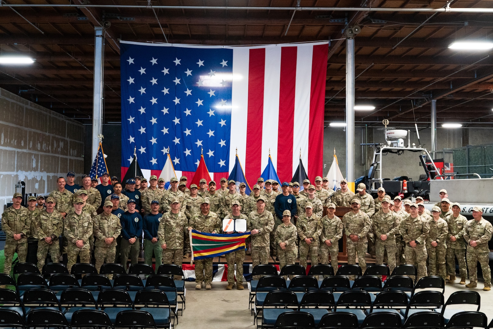 U.S. Coast Guard service members pose for a group picture upon receiving a unit commendation medal during a change of command ceremony for the Coast Guard Maritime Security Response Team West in San Diego, July 9, 2025.  MSRT West is the Coast Guard’s short-notice maritime response and counter-terrorism unit on the west coast with personnel capable of conducting maritime threat response as part of a Coast Guard or interagency adaptive force package. (U.S. Coast Guard photo by Petty Officer 3rd Class Ian Nuhfer)