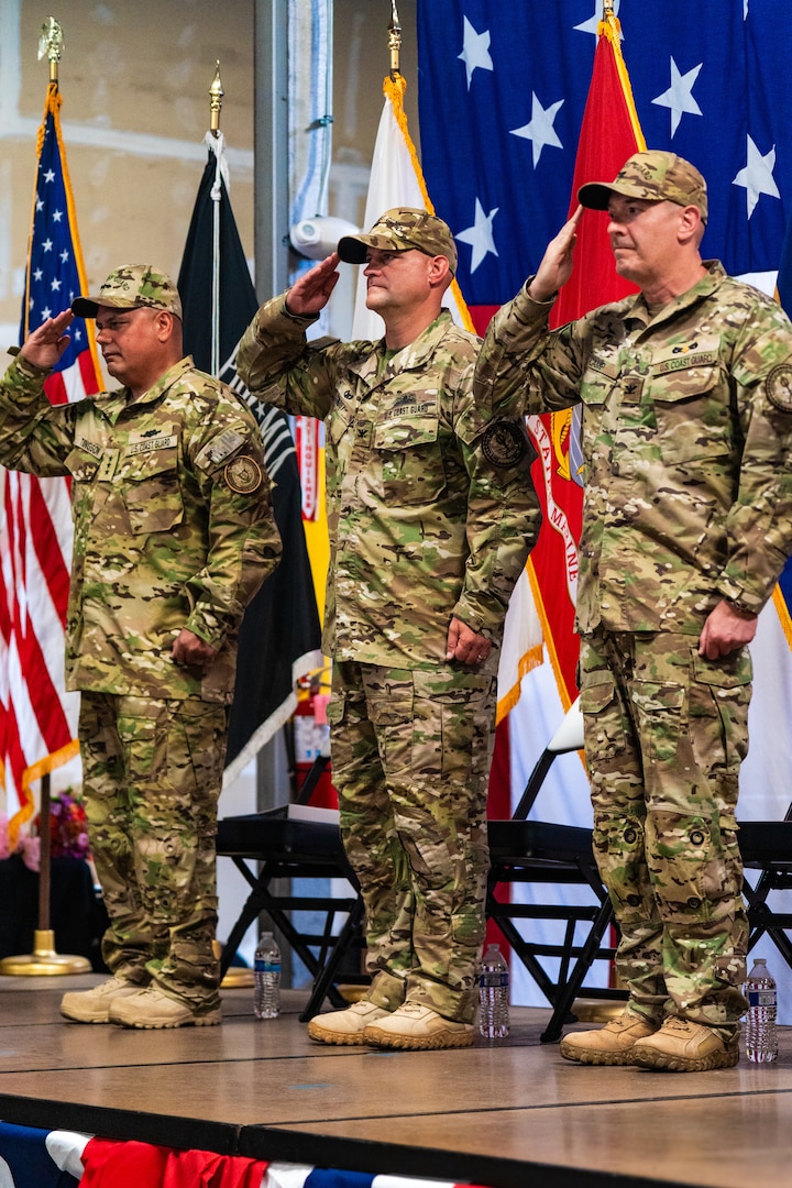 Vice Adm. Andrew Tiongson (Left), Capt. Robert J. Berry (Center), and Capt. James J. Camp (Right) render salute during a change of command ceremony for the Coast Guard Maritime Security Response Team West in San Diego, July 9, 2025.  The change of command ceremony is a time-honored tradition and formal ritual conducted before the assembled company of a command to confirm to the unit’s men and women that the authority of command is maintained. The ceremony is a transfer of total responsibility, authority, and accountability from one individual to another. (U.S. Coast Guard photo by Petty Officer 3rd Class Ian Nuhfer)