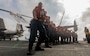 Sailors, assigned to deck department’s forward division, heave a phone-and-distance line on the flight deck of Nimitz-class aircraft carrier USS George Washington (CVN 73) during a fueling-at-sea evolution with Military Sealift Command chartered ship motor tanker Badlands Trader while underway in the Celebes Sea, July 10, 2025.