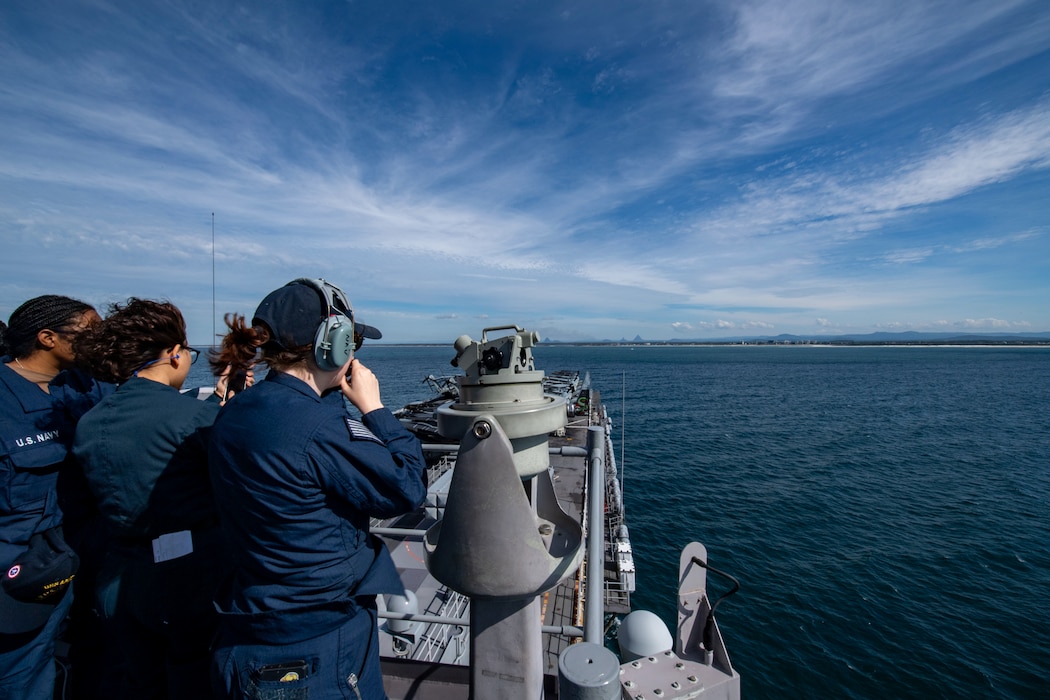 Sailors assigned to the forward-deployed amphibious assault ship USS America (LHA 6) conduct sea and anchor on the ship’s forward lookout, while pulling into Brisbane, July 9.