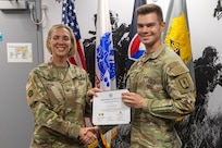 Col. Michelle M. Williams, U.S. Army Financial Management Command commander, presents 2nd Lt. Jacob Dease, National Guard Professional Education Center financial management training development support officer, with a certificate of completion for graduating the U.S. Army Operational Banking Short Course at the Maj. Gen. Emmett J. Bean Federal Center in Indianapolis June 6, 2025. USAFMCOM created the course to prepare more finance and comptroller officers and senior noncommissioned officers to serve as banking officers around the globe. (U.S. Army photo by Brad Staggs)