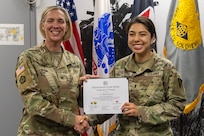 Col. Michelle M. Williams, U.S. Army Financial Management Command commander, presents 1st Lt. Elena Guerra, Security Assistance Group – Ukraine Resource Management (J8) budget analyst, with a certificate of completion for graduating the U.S. Army Operational Banking Short Course at the Maj. Gen. Emmett J. Bean Federal Center in Indianapolis June 6, 2025. USAFMCOM created the course to prepare more finance and comptroller officers and senior noncommissioned officers to serve as banking officers around the globe. (U.S. Army photo by Brad Staggs)