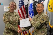 Col. Michelle M. Williams, U.S. Army Financial Management Command commander, presents Sgt. 1st Class Jung Lee, I Corps Resource Management (G8) budget analyst, with a certificate of completion for graduating the U.S. Army Operational Banking Short Course at the Maj. Gen. Emmett J. Bean Federal Center in Indianapolis June 6, 2025. USAFMCOM created the course to prepare more finance and comptroller officers and senior noncommissioned officers to serve as banking officers around the globe. (U.S. Army photo by Brad Staggs)