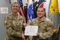 Col. Michelle M. Williams, U.S. Army Financial Management Command commander, presents 1st Lt. Jon Linebery, 12th Finance Operations Center operations officer, with a certificate of completion for graduating the U.S. Army Operational Banking Short Course at the Maj. Gen. Emmett J. Bean Federal Center in Indianapolis June 6, 2025. USAFMCOM created the course to prepare more finance and comptroller officers and senior noncommissioned officers to serve as banking officers around the globe. (U.S. Army photo by Brad Staggs)