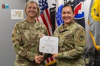 Col. Michelle M. Williams, U.S. Army Financial Management Command commander, presents Sgt. 1st Class Veronica Ramos, USAFMCOM executive officer to the senior enlisted advisor, with a certificate of completion for graduating the U.S. Army Operational Banking Short Course at the Maj. Gen. Emmett J. Bean Federal Center in Indianapolis June 6, 2025. USAFMCOM created the course to prepare more finance and comptroller officers and senior noncommissioned officers to serve as banking officers around the globe. (U.S. Army photo by Brad Staggs)