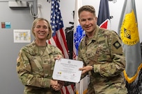 Col. Michelle M. Williams, U.S. Army Financial Management Command commander, presents Capt. Daniel Solomon, 224th Finance Battalion Headquarters and Headquarters Company commander and banking officer, with a certificate of completion for graduating the U.S. Army Operational Banking Short Course at the Maj. Gen. Emmett J. Bean Federal Center in Indianapolis June 6, 2025. USAFMCOM created the course to prepare more finance and comptroller officers and senior noncommissioned officers to serve as banking officers around the globe. (U.S. Army photo by Brad Staggs)