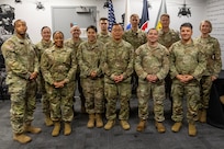Col. Michelle M. Williams, U.S. Army Financial Management Command commander, far right, and Maj. Terrell Murdock, USAFMCOM banking officer, far left, pose with ten officers and senior noncommissioned officers graduating the U.S. Army Operational Banking Short Course at the Maj. Gen. Emmett J. Bean Federal Center in Indianapolis June 6, 2025. USAFMCOM created the course to prepare more finance and comptroller officers and senior NCOs to serve as banking officers around the globe. (U.S. Army photo by Brad Staggs)