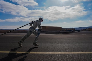 An Air Commando assigned to the 27th Special Operations Wing pulls a hose connected to an MC-130 Commando II for a forward arming and refueling point demonstration for Chilean Airmen at Antofagasta, Chile, May 29, 2025 as part of Southern Star 2025