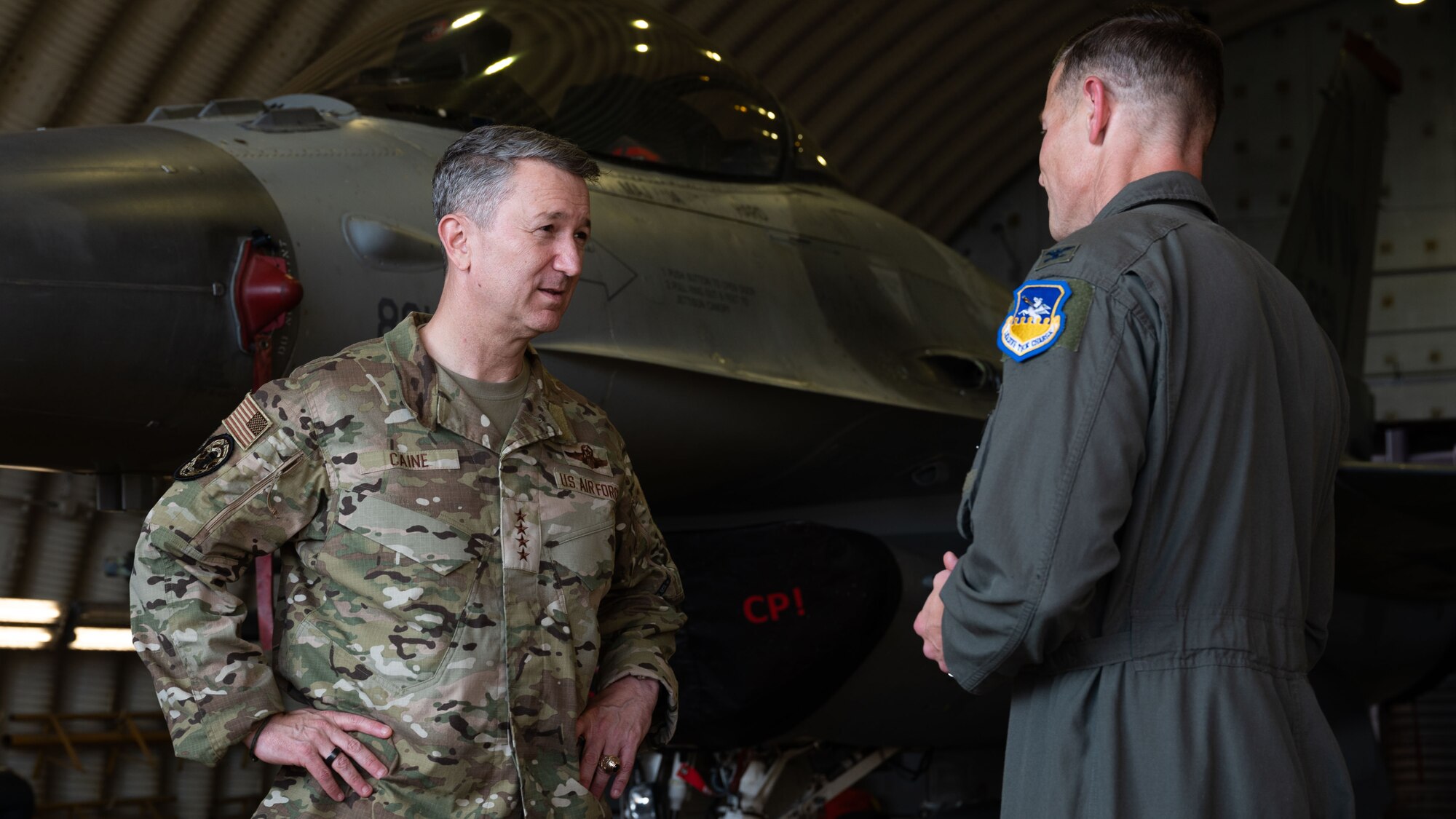 U.S. Air Force Gen. Dan Caine, left, Chairman of the Joint Chiefs of Staff, discusses 51st Fighter Wing operations with Col. Ryan Ley, 51st FW commander, at Osan Air Base, Republic of Korea, July 11, 2025. During his visit, Osan leadership highlighted the super squadron test and how it supports the wing’s “Fight Tonight” mission. (U.S. Air Force photo by Senior Airman Rome Bowermaster)
