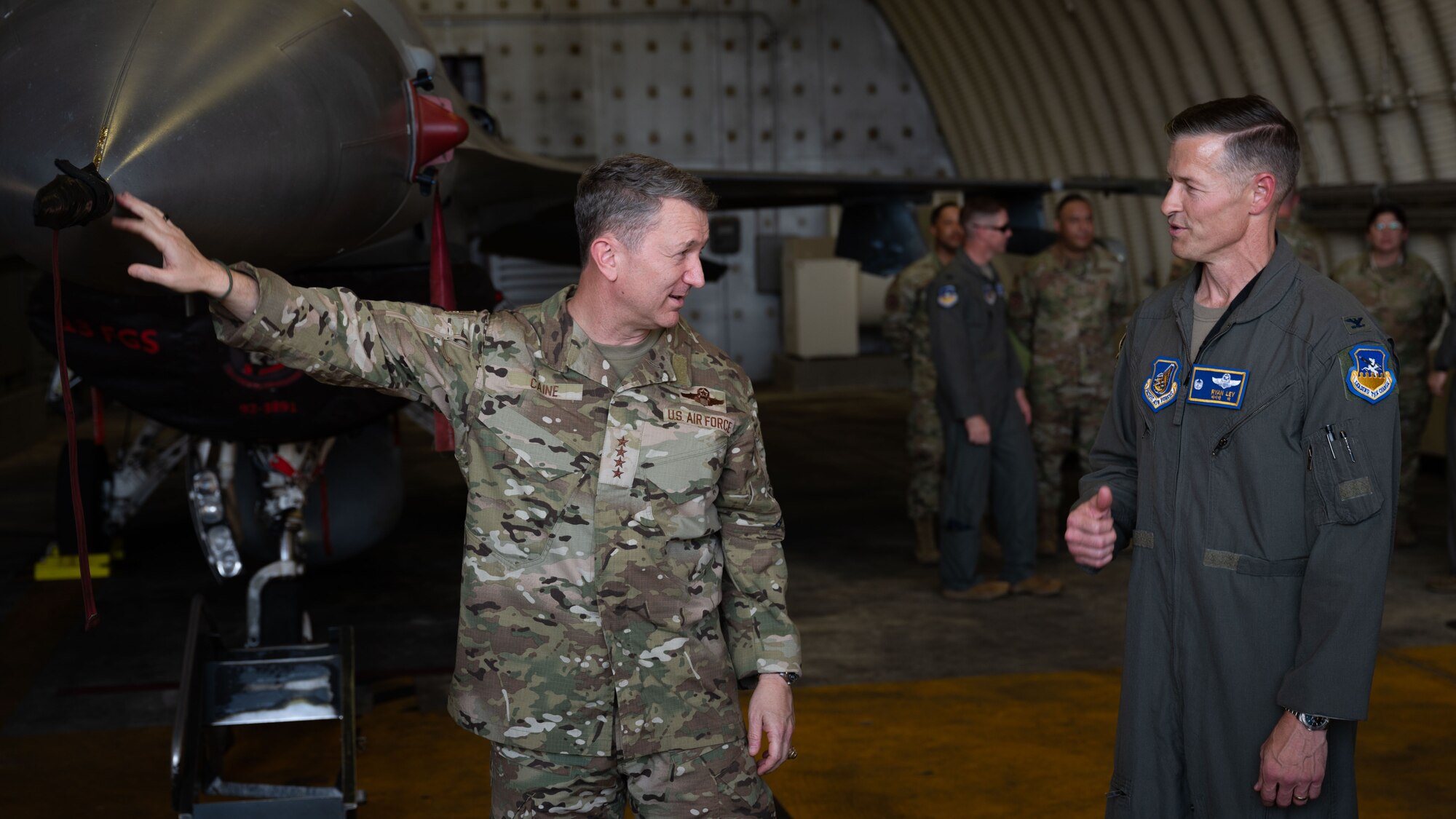 U.S. Air Force Gen. Dan Caine, left, Chairman of the Joint Chiefs of Staff, discusses 51st Fighter Wing operations with Col. Ryan Ley, 51st FW commander, at Osan Air Base, Republic of Korea, July 11, 2025. Osan served as the final stop during the Chairman’s visit to Korea in support of the annual Trilateral Chiefs of Defense meeting. (U.S. Air Force photo by Senior Airman Rome Bowermaster)