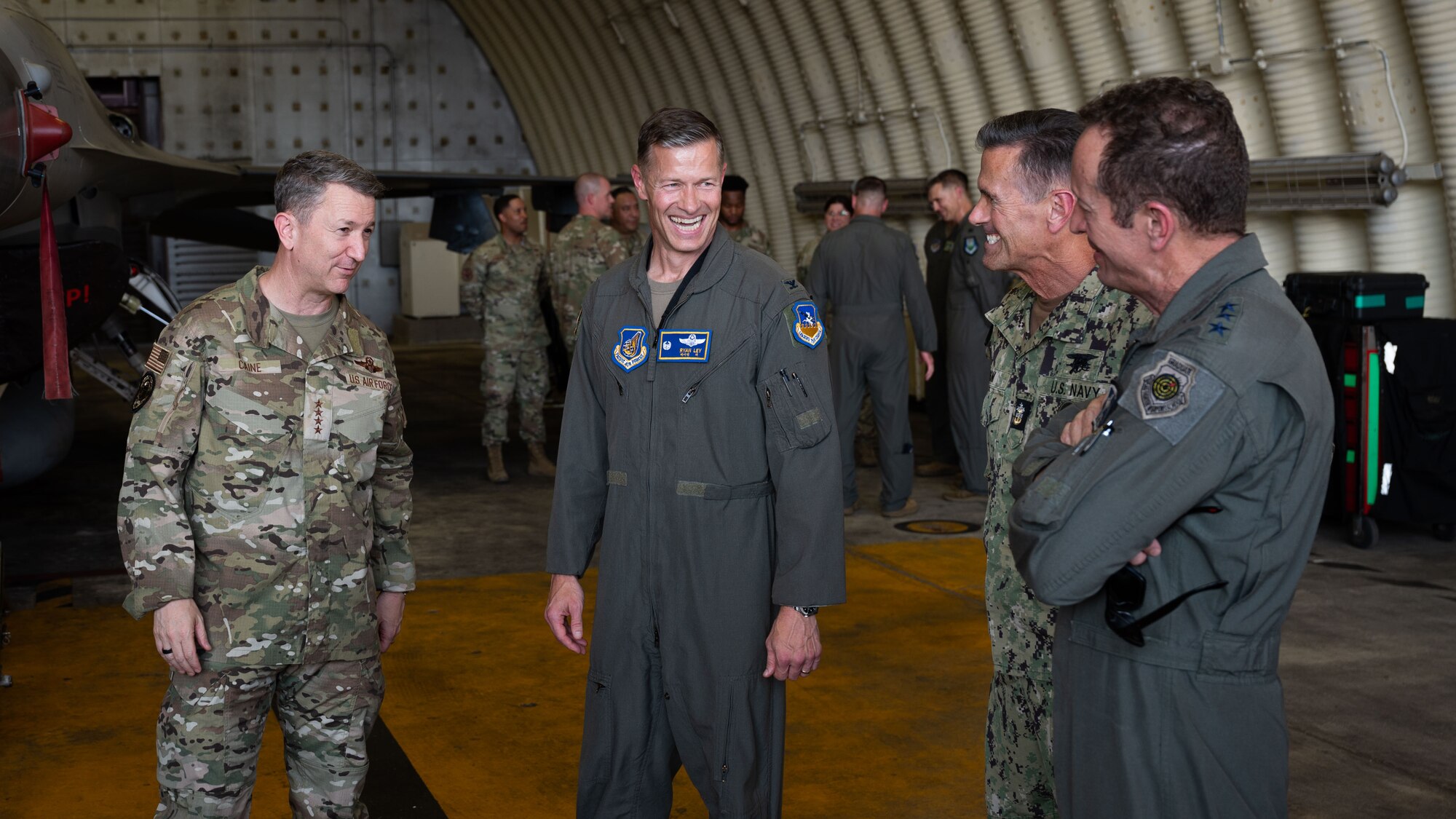 U.S. Air Force Gen. Dan Caine, left, Chairman of the Joint Chiefs of Staff, Col. Ryan Ley, center, 51st Fighter Wing commander, Senior Enlisted Advisor to the Joint Chiefs of Staff Fleet Master Chief Petty Officer David Isom, second from right, and Lt. Gen. David Iverson, far right, Seventh Air Force commander, discuss 51st FW operations at Osan Air Base, Republic of Korea, July 11, 2025. CJCS and SEAC visited Korea as part of the annual Trilateral Chiefs of Defense meeting and concluded their trip at Osan with a tour of the air operations center and a troop engagement. (U.S. Air Force photo by Senior Airman Rome Bowermaster)