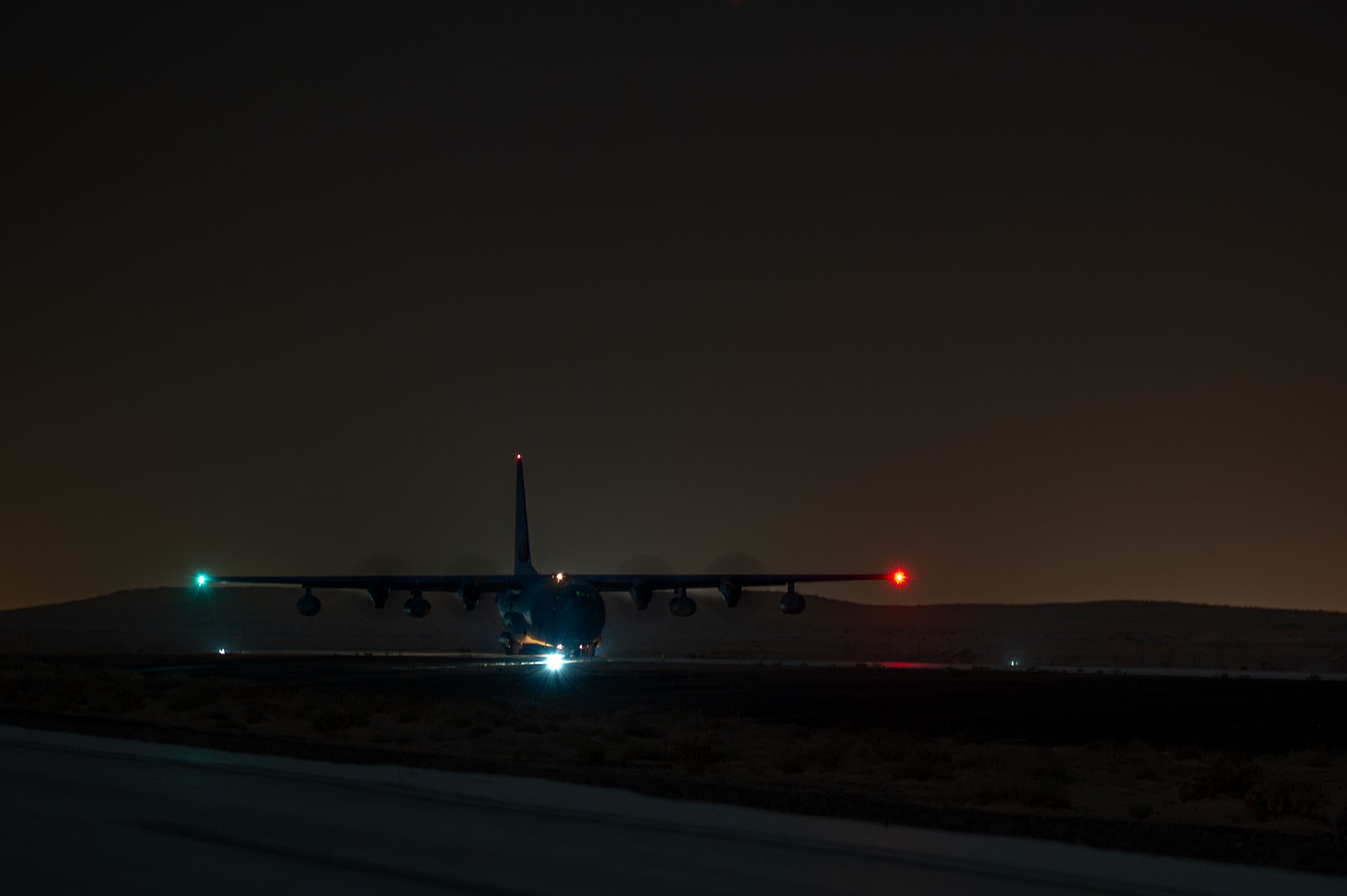 A U.S. Air Force HC-130J Combat King II assigned to the 26th Expeditionary Rescue Squadron unloads cargo.