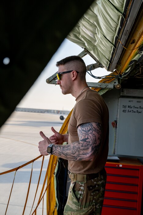 U.S. Air Force Tech. Sgt. William Schunk, 32nd Expeditionary Aerial Refueling Squadron boom operator, directs a K-loader within the U.S. Central Command area of responsibility, June 12, 2025. Boom operators primarily specialize in aerial refueling but also support cargo transport, passenger coordination, and aeromedical evacuations when not actively refueling. (U.S. Air Force photo by Senior Airman Amanda Jett)