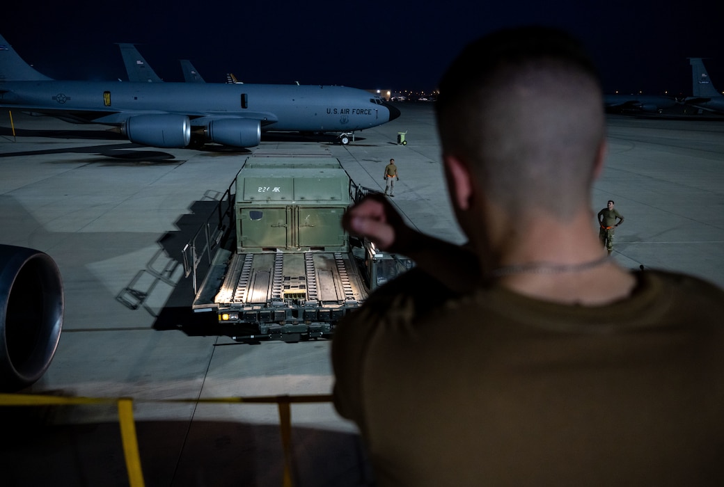 U.S. Air Force Tech. Sgt. William Schunk, 32nd Expeditionary Aerial Refueling Squadron boom operator, directs a K-loader within the U.S. Central Command area of responsibility, June 12, 2025. Boom operators primarily specialize in aerial refueling but also support cargo transport, passenger coordination and aeromedical evacuations when not actively refueling. (U.S. Air Force photo by Senior Airman Amanda Jett)