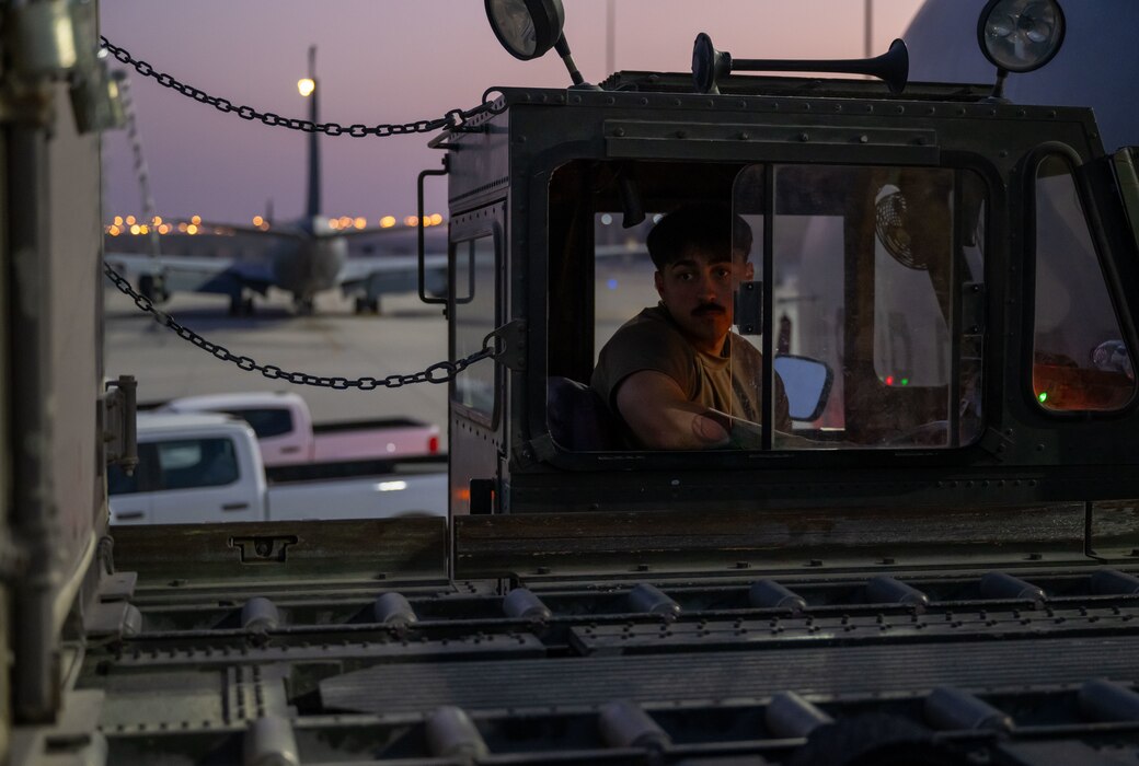 A U.S. Airman, forward deployed to the 379th Air Expeditionary Wing, operates a K-loader within the U.S. Central Command area of responsibility, June 12, 2025.  As one of Ninth Air Force (Air Forces Central)’s expeditionary wings, the 379th AEW supports a wide range of missions to include humanitarian airlift activities, mission-essential combat power, aeromedical evacuation and intelligence support for multiple-theater operations. (U.S. Air Force photo by Senior Airman Amanda Jett)