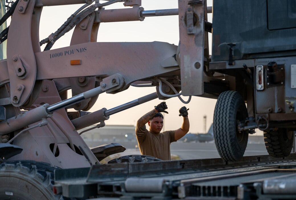 A U.S. Airman, forward deployed to the 379th Air Expeditionary Wing, directs a forklift during cargo upload within the U.S. Central Command area of responsibility, June 12, 2025. As one of Ninth Air Force (Air Forces Central)’s expeditionary Wings, the 379th AEW supports a wide range of missions to include humanitarian airlift activities, mission-essential combat power, aeromedical evacuation and intelligence support for multiple-theater operations. (U.S. Air Force photo by Senior Airman Amanda Jett)