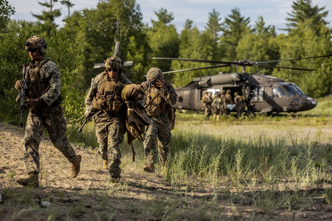 U.S. Marines and sailors with 1st Battalion, 8th Marine Regiment, 2d Marine Division, participate in a mass casualty evacuation simulation in support of exercise Atlantic Alliance 2025 (AA25) on Bangor International Airport, Maine, July 10, 2025. AA25 is the premier East Coast naval integration exercise, featuring over 25 U.S. Navy and Marine Corps units alongside Dutch naval forces and British Royal Commandos. Spanning from North Carolina to Maine, AA25 will showcase a range of dynamic events including force integration, air assault operations, bilateral reconnaissance, naval strait transits, amphibious assault training, and a simulated war-at-sea exercise. (U.S. Marine Corps photo by Cpl. Grace Stover)