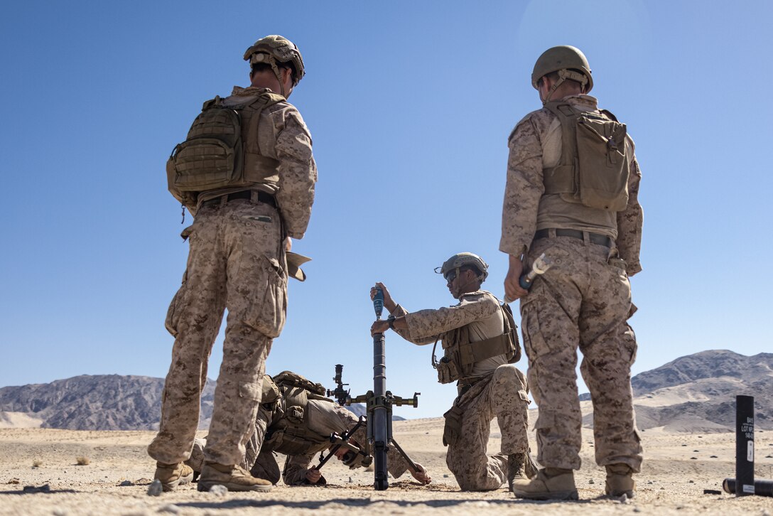 U.S. Marines with 2d Battalion, 8th Marines, 6th Marine Regiment, 2d Marine Division prepare to fire an M224 61mm mortar system during Service Level Training Exercise 4-25, on Range 106 at Marine Corps Air-Ground Combat Center, Twentynine Palms, California, July 12, 2025. SLTE 4-25 is designed to be a challenging, realistic training environment that produces combat-ready forces capable of operating as an integrated Marine Air Ground Task Force across all domains of military operations. (U.S. Marine Corps photo by Lance Cpl. Judith Ann Lazaro)