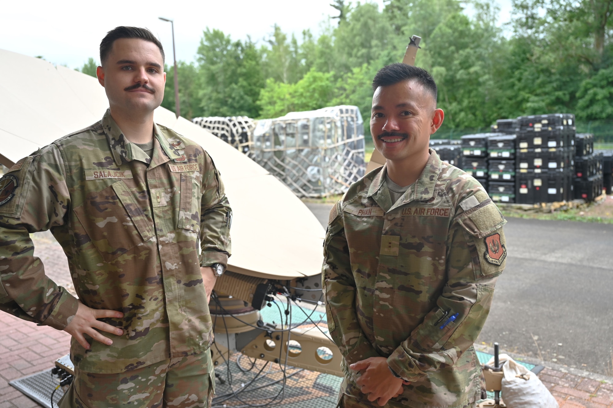 Warrant Officer Franko Salajcik, technical integrator, 1st Combat Communications Squadron (Left), and Chief Warrant Officer 2 Louis Phan, technical integrator, 435th Communications Operations Group (Right), pose for a photo at Ramstein Air Base, Germany, July 11, 2025. They are among the first Warrant Officers in in U.S. Air Forces in Europe, where they will leverage their expertise to enhance operational effectiveness. (U.S. Air Force photo by Capt. Lou Burton)
