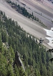 An Oregon Army National Guard HH-60M Black Hawk helicopter, assigned to the 641st Aviation Regiment, conducts a search and rescue mission on July 13, 2025, in the caldera at Crater Lake National Park, Oregon. The same Black Hawk later in the day conducted a second rescue mission at Lake Harriett, Southeast of Crater Lake, when three hikers were injured from a falling tree limb.