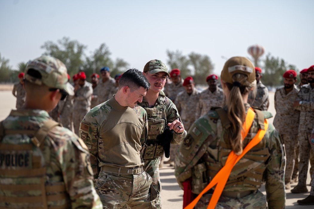 Two USAF Airmen demonstrate handcuffing procedures during an exercise