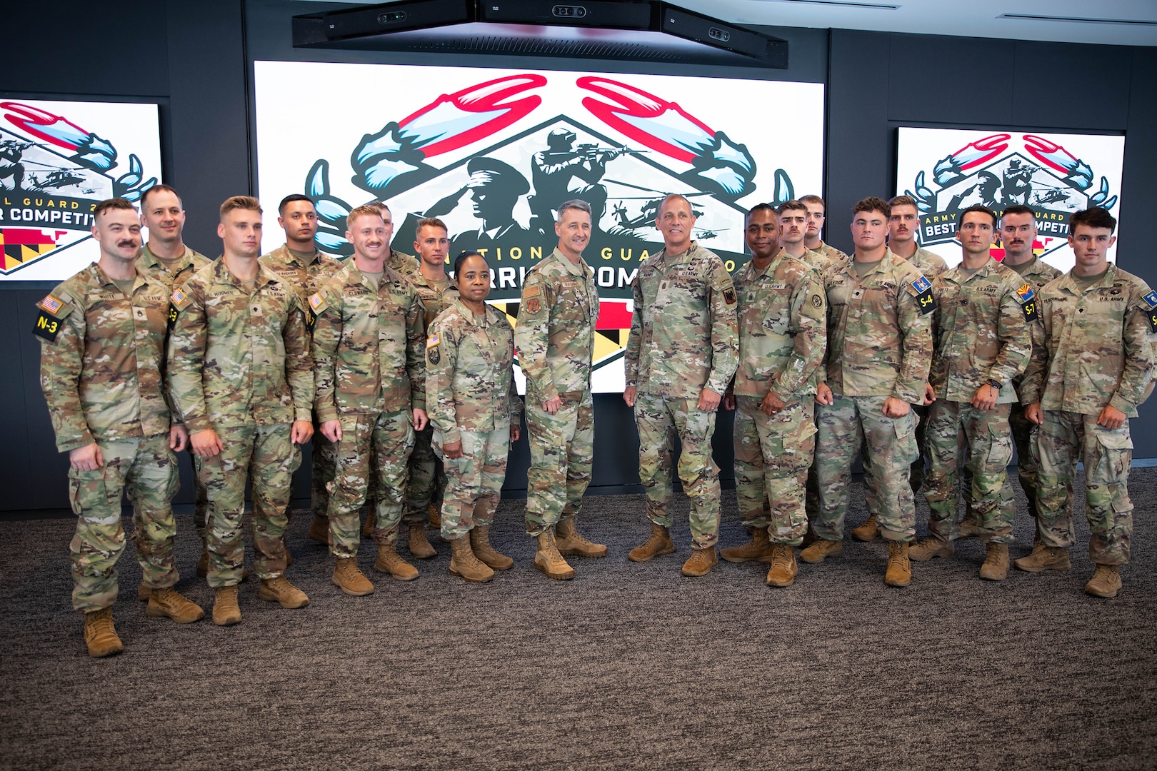 Gen. Steven Nordhaus, chief of the National Guard Bureau, Senior Enlisted Advisor John Raines III, SEA to the chief of the National Guard Bureau, Maj. Gen. Janeen Birckhead, the Adjutant General of Maryland and Command Sgt. Maj. David C. Harry, senior enlisted leader of the Maryland Army National Guard, pose for a photo with competitors in the Army National Guard’s 2025 Best Warrior Competition on July 12, 2025, at Under Armour Headquarters in Baltimore, Maryland.