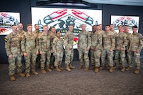 Gen. Steven Nordhaus, chief of the National Guard Bureau, Senior Enlisted Advisor John Raines III, SEA to the chief of the National Guard Bureau, Maj. Gen. Janeen Birckhead, the Adjutant General of Maryland and Command Sgt. Maj. David C. Harry, senior enlisted leader of the Maryland Army National Guard, pose for a photo with competitors in the Army National Guard’s 2025 Best Warrior Competition on July 12, 2025, at Under Armour Headquarters in Baltimore, Maryland.