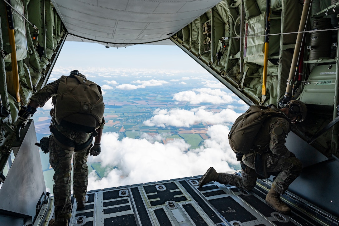 A U.S. Air Force Special Tactics Operator assigned to the 24th Special Operations Wing and a U.S. Army Special Forces Operator perform safety checks prior to a bi-lateral military free fall from a U.S. Air Force MC-130J Commando II assigned to the 352d Special Operations Wing near Vinnytsia, Ukraine, Aug. 10, 2021.