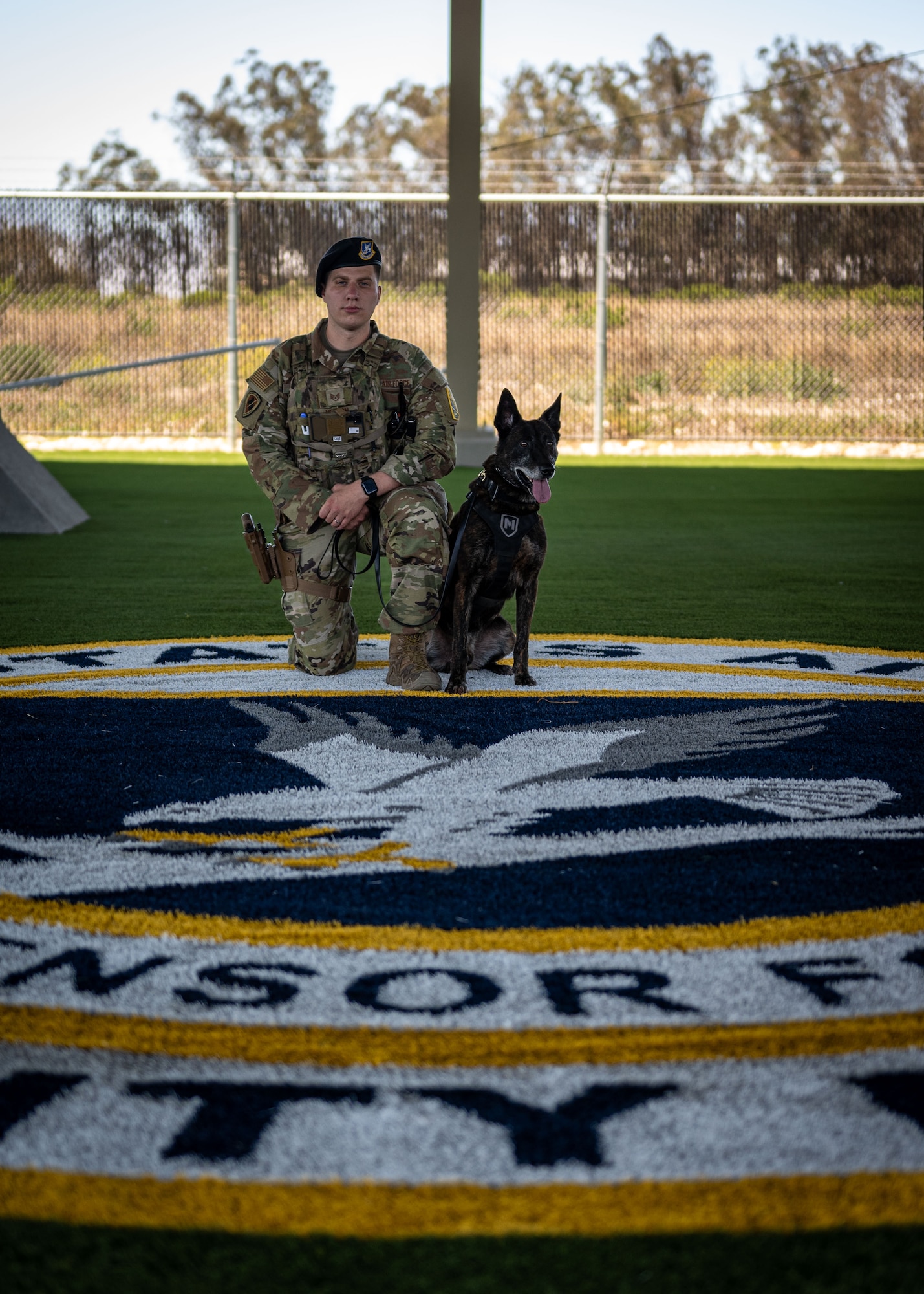 U.S. Air Force Staff Sgt. Trey Nelson, 30th Security Forces Squadron military working dog handler, and MWD Ringo, pose for a photo at Vandenberg Space Force Base, Calif., July 11, 2025. Military working dogs and their handlers work hand-in-paw to patrol, detect drugs and explosives, and perform specialized mission functions for the Department of Defense and other government agencies.