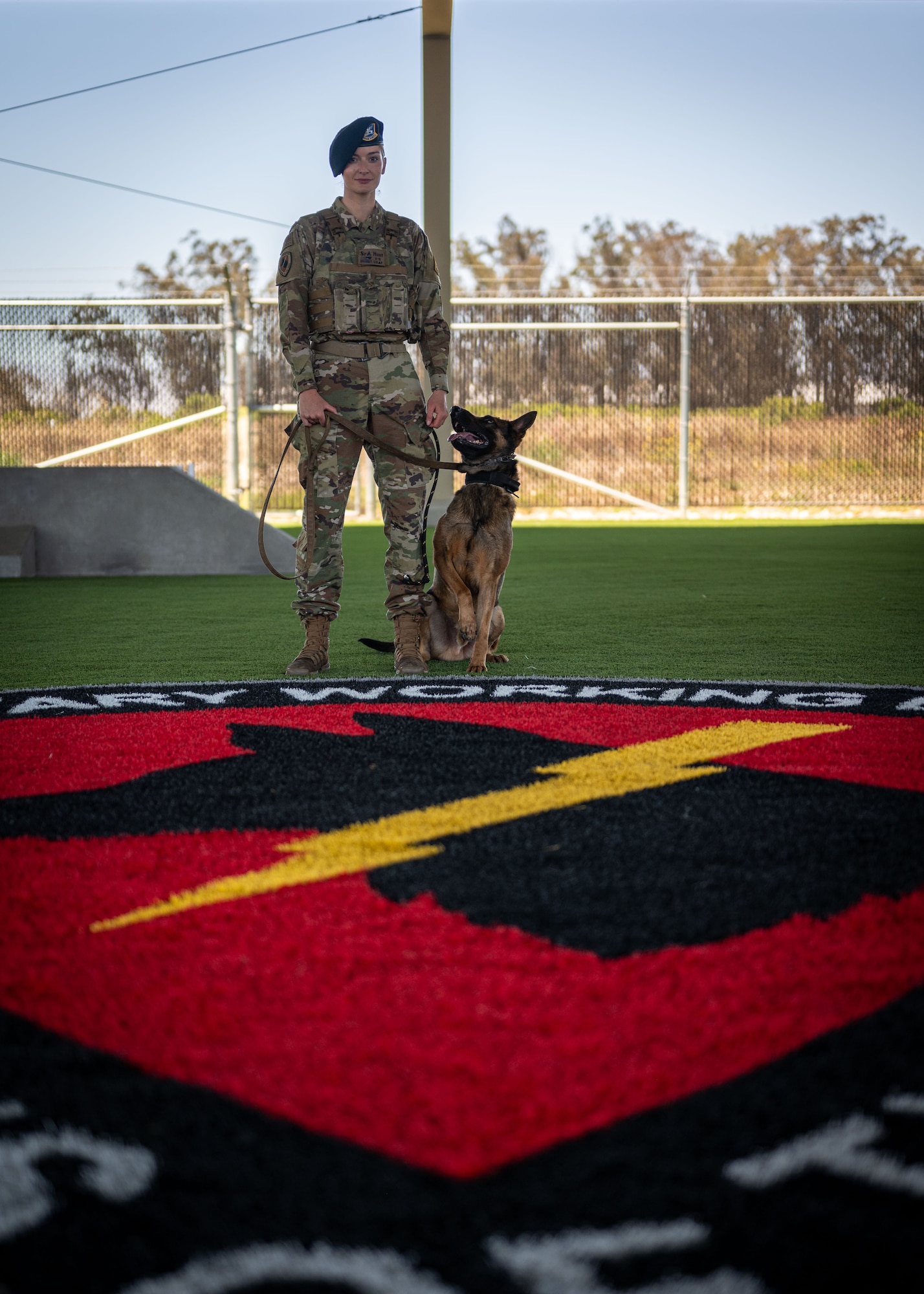 U.S. Air Force Senior Airman Cassidy Hunt, 30th Security Forces Squadron military working dog handler, and MWD Maugli, pose for a photo at Vandenberg Space Force Base, Calif., July 11, 2025. Military working dogs and their handlers work hand-in-paw to patrol, detect drugs and explosives, and perform specialized mission functions for the Department of Defense and other government agencies.